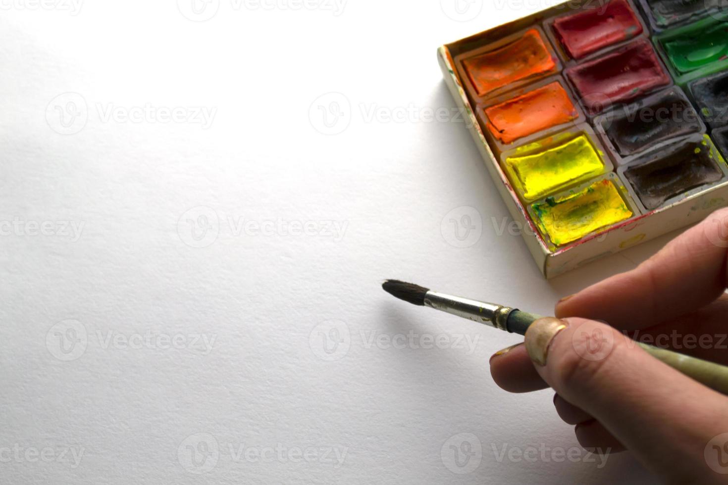 A woman paints with watercolors. photo