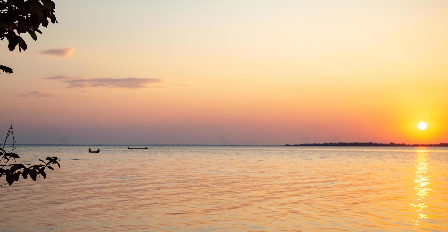 Foliage shadows along the shore, twilight, fishermen's boats.  travel background design template book cover website photo