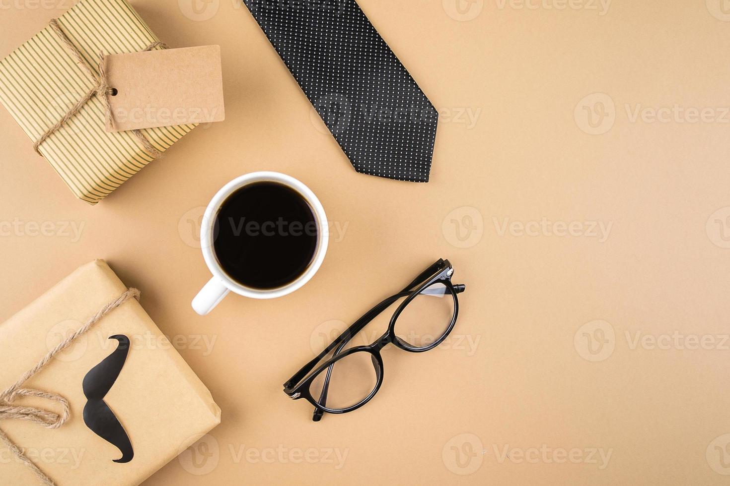 Happy Fathers Day concept. Gift present boxes, eyeglasses, tie, cup of coffee on neutral background. photo