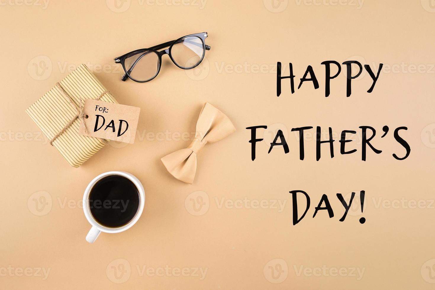 Happy Fathers Day Greeting Card. Gift present box, eyeglasses, butterfly, cup of coffee on background. photo