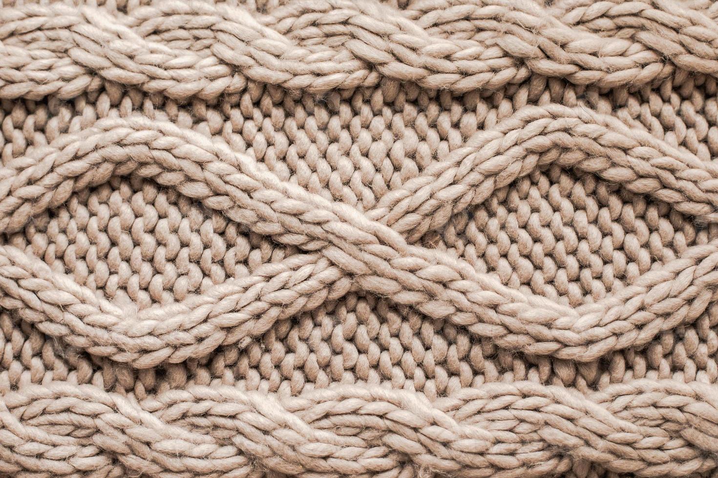 Beige knitting wool texture background. Woolen handmade knitted