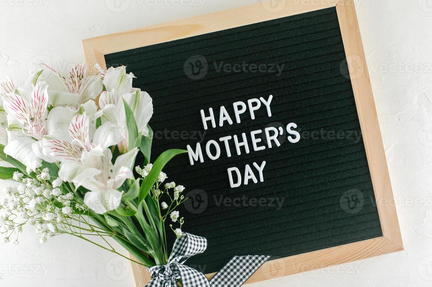 Mother's Day greetings card. Alstroemeria, gypsophila, letters board with text Happy Mothers Day photo