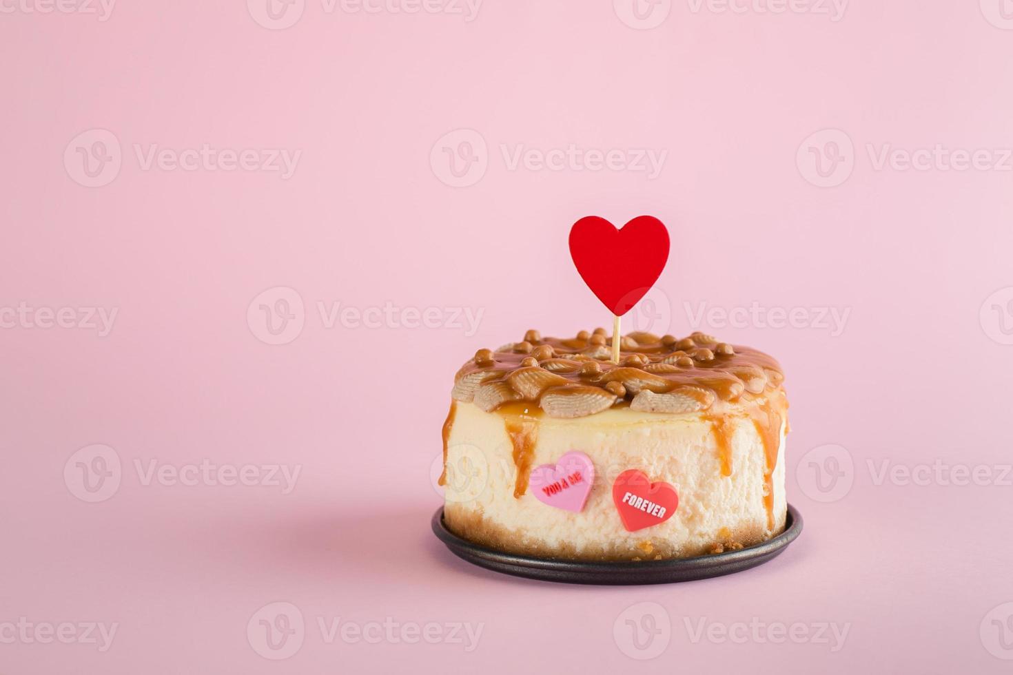 Valentine's day concept. Small bento cheesecake decorated with small hearts topper. Copy space photo