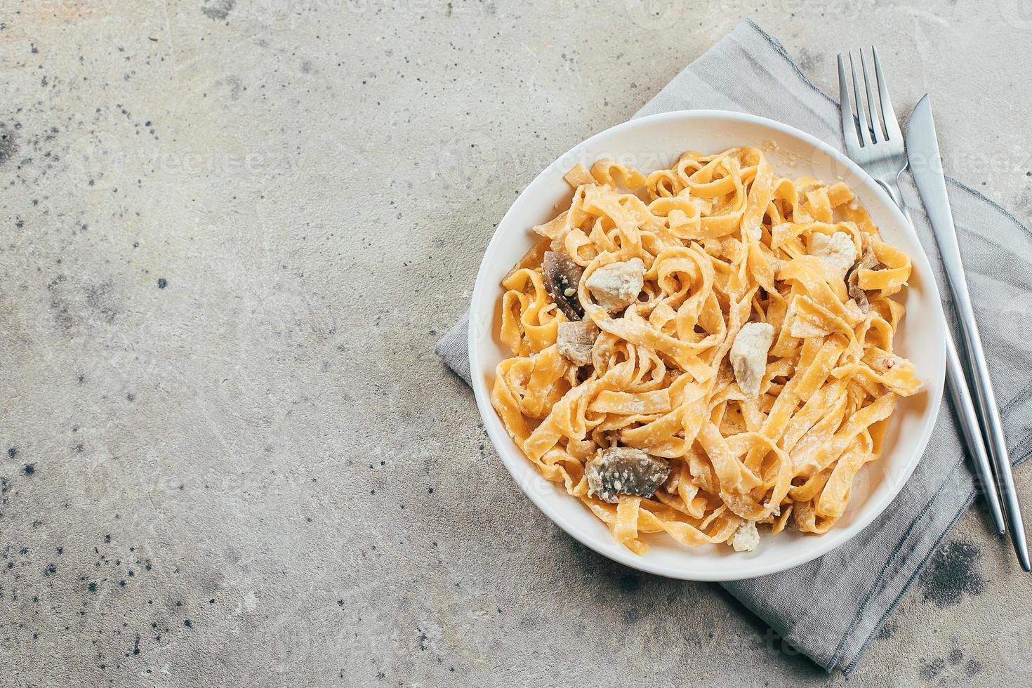 Italian pasta fettuccine alfredo with chicken, mushrooms and sauce on
