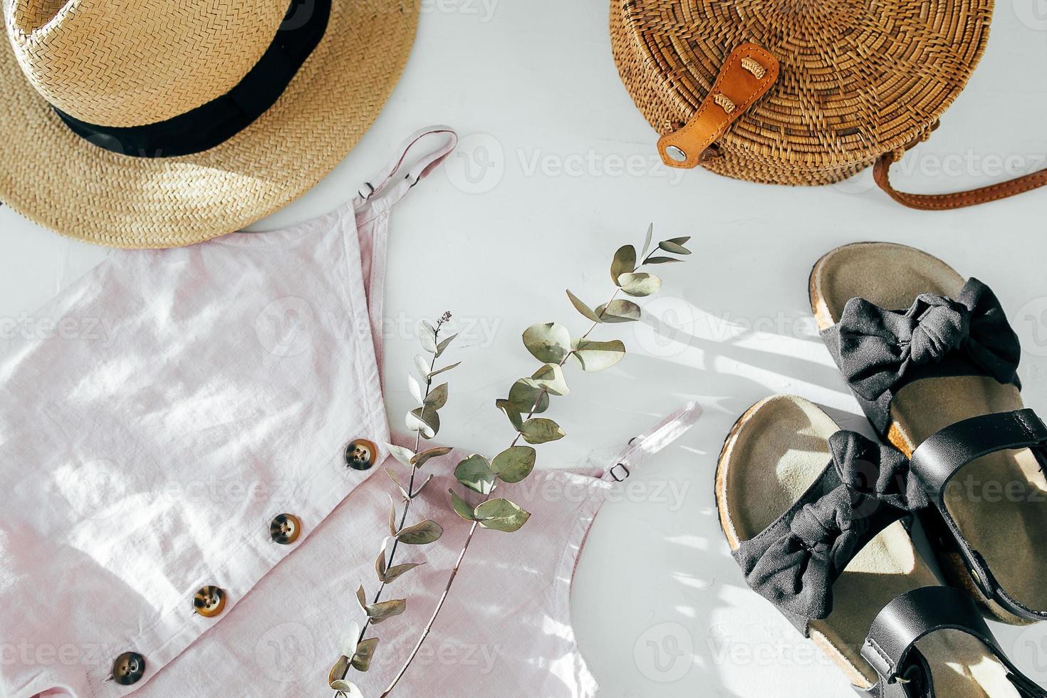 Beauty blog concept. Summer female clothes, accessories. Black sandals, top, straw hat, rattan bag photo