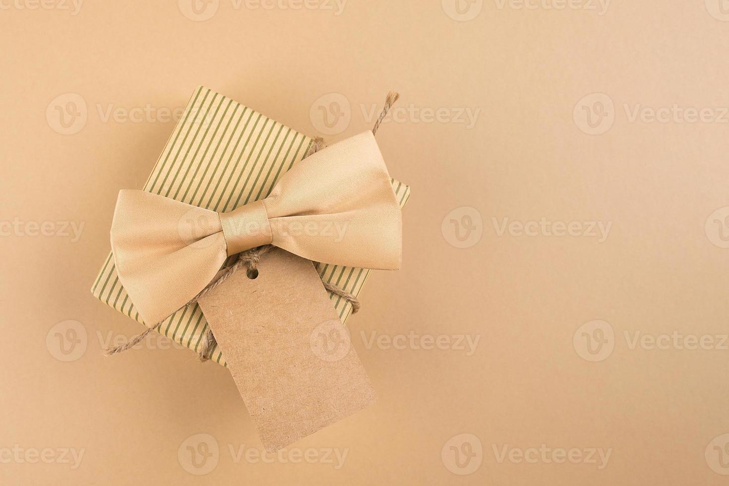 Gift box with label for text on neutral background. Happy Fathers Day concept. Monochrome image photo