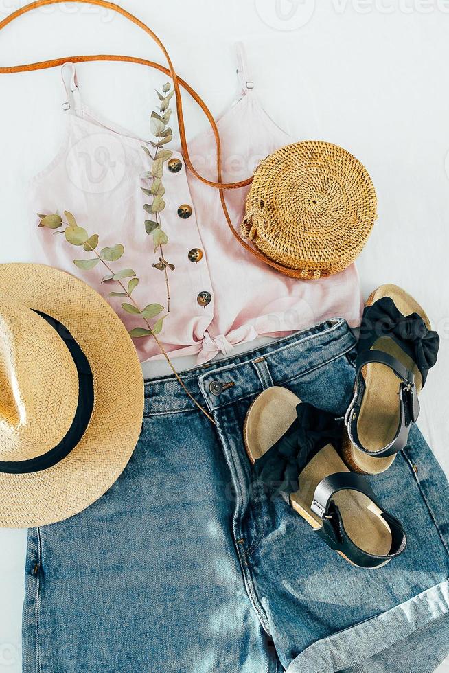 Women's fashion summer clothes, accessories. Stylish female straw hat, denim short, top, sandals photo