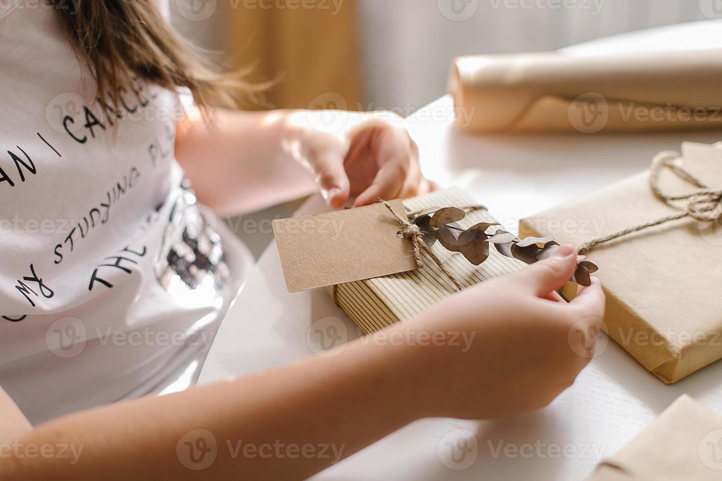 Female preparing plastic free christmas present. Concept of zero waste holiday Christmas photo