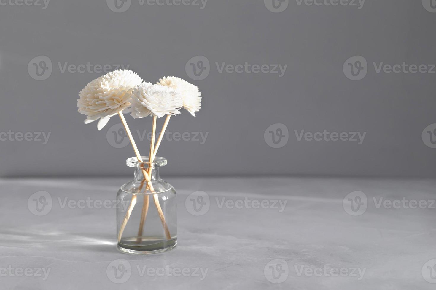 Aromatic reed air freshener on marble table background. Hygge, cozy concept. Copy space photo