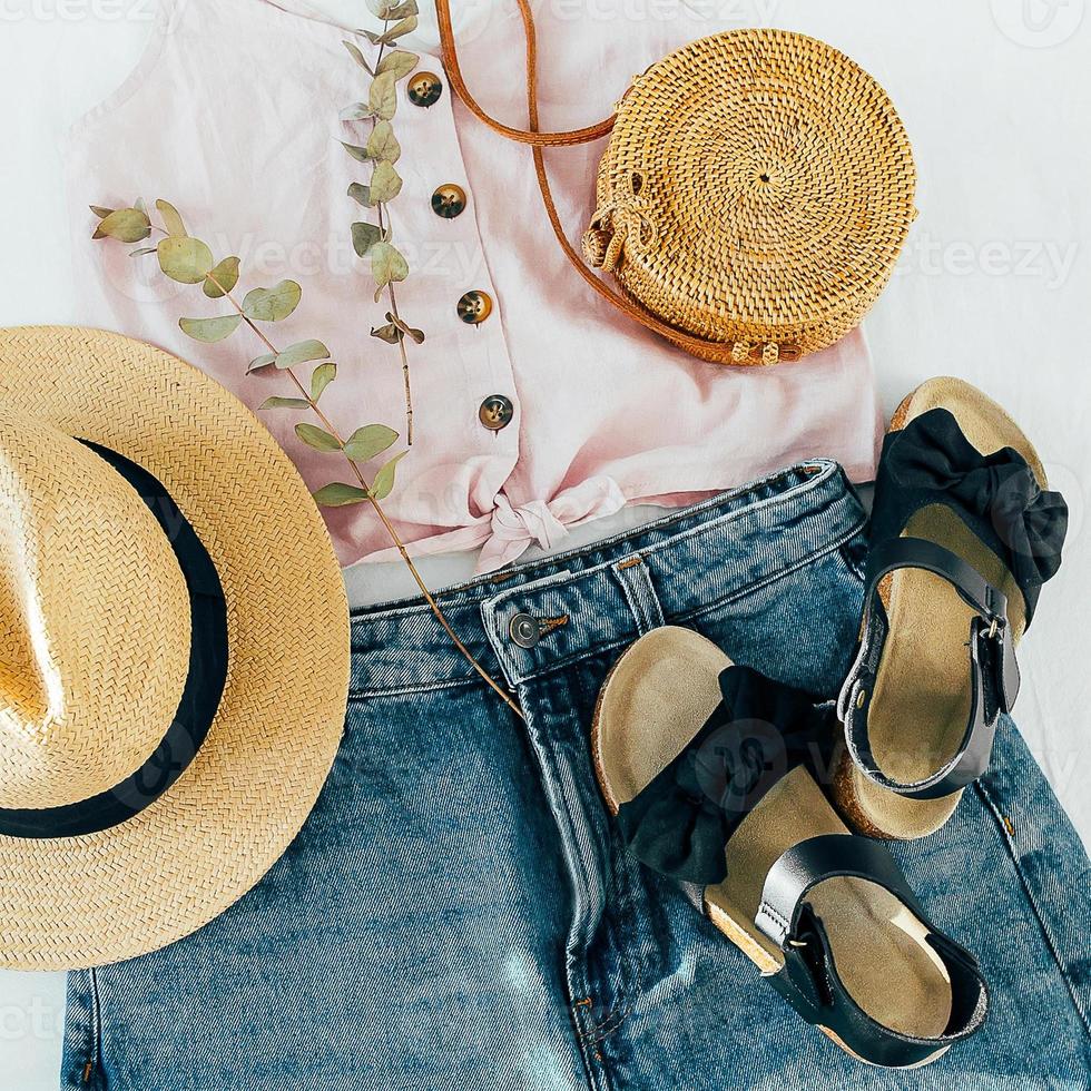 Women's fashion summer clothes, accessories. Stylish female straw hat, denim short, top, sandals photo