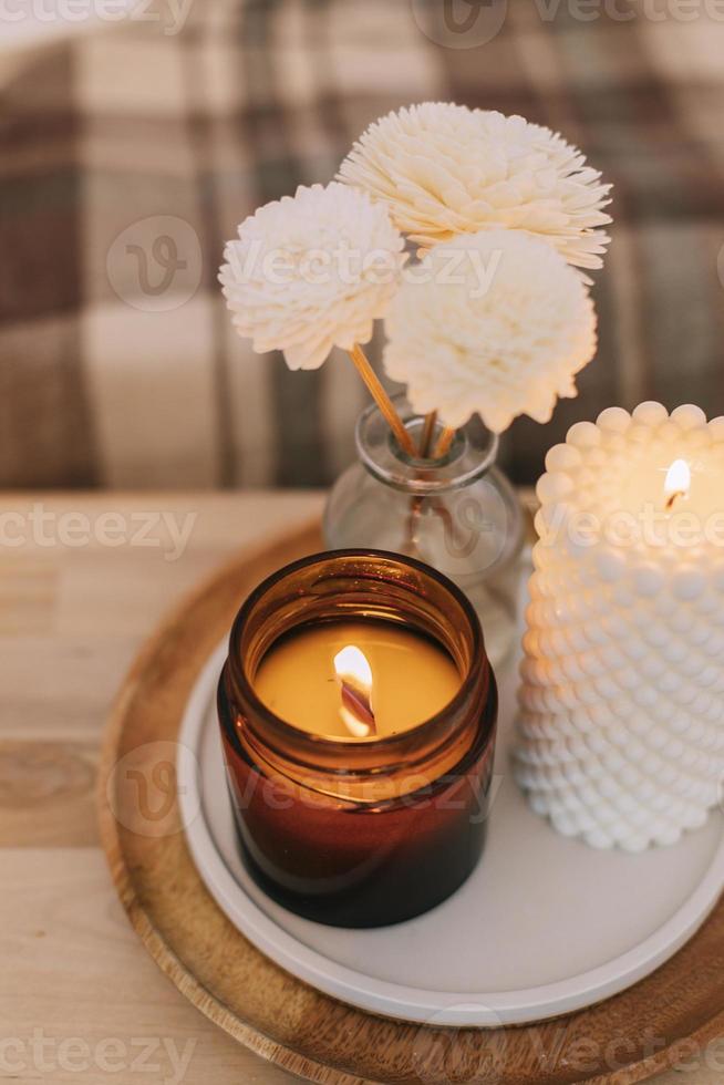 Home aroma fragrance diffuser and burning candles with wooden wick. Interior elements. photo