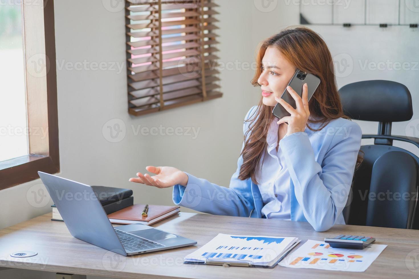 Marketing, Financial, Accounting, Planning, businesswomen uses a mobile phone to contact a customer to inform her of the company is business partnership. photo