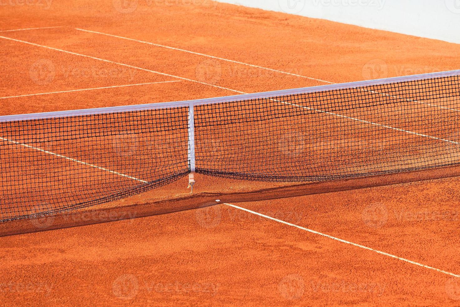 Empty Clay Tennis Court and Net photo