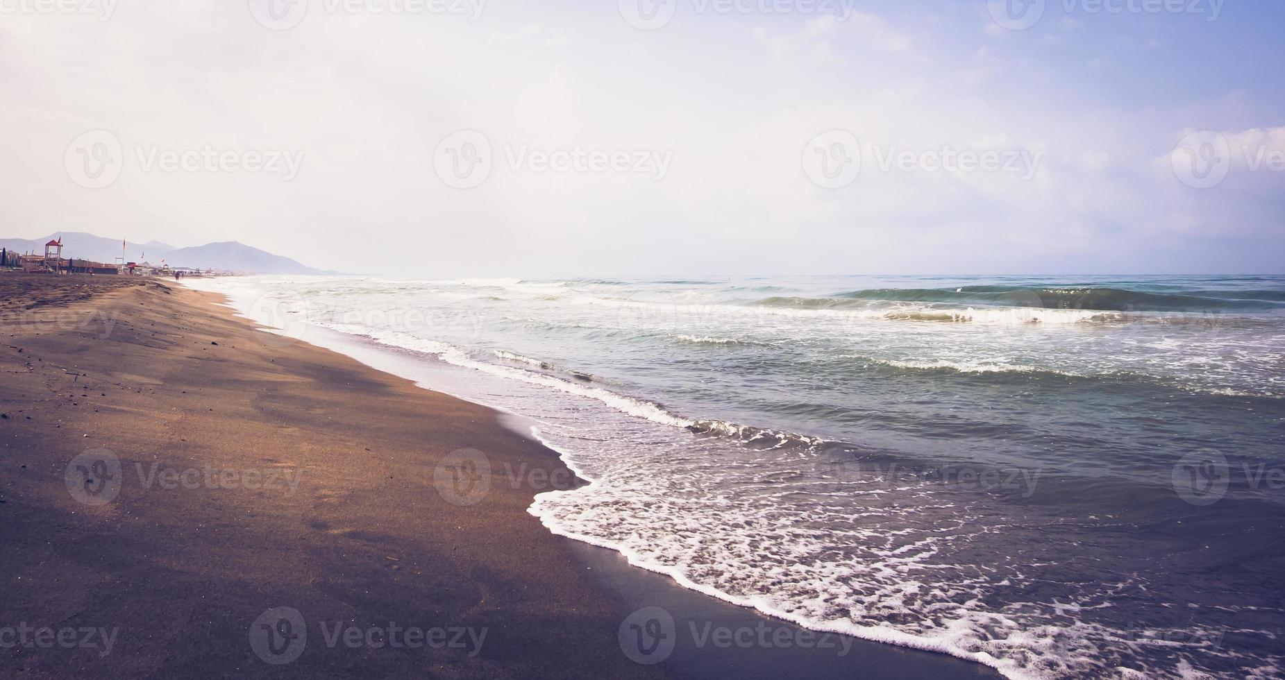 Sea wave on sandy beach photo