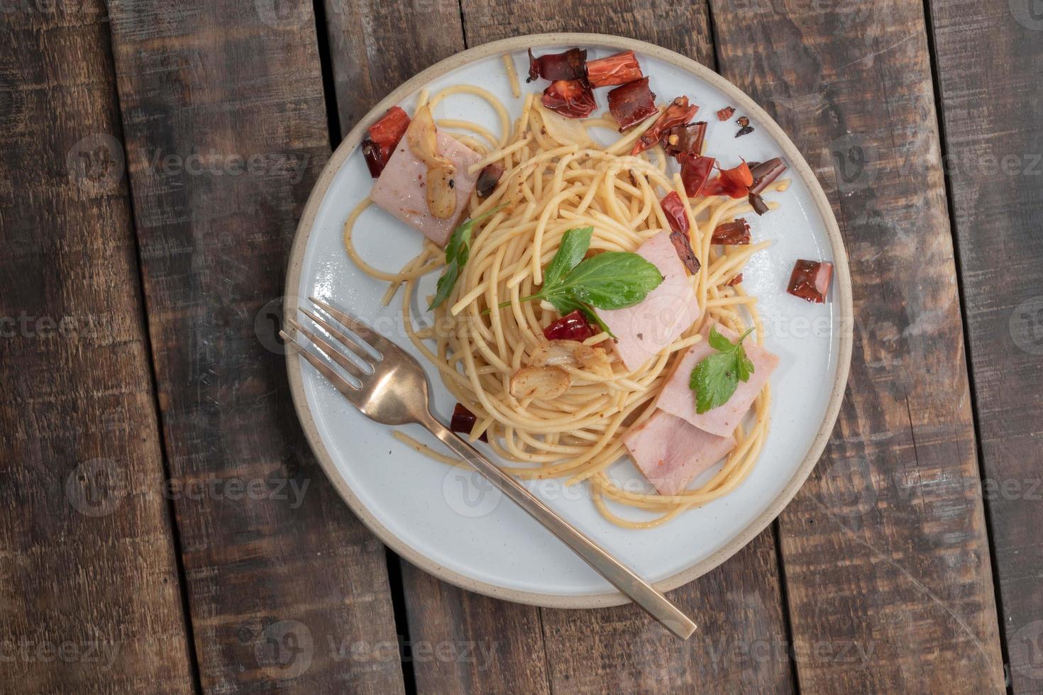 Pasta in white plate on wood background Italian food. photo