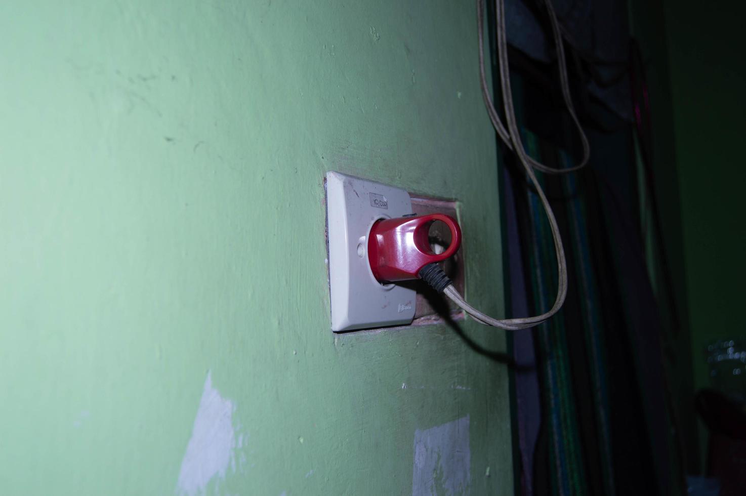 socket located on the wall of the house photo