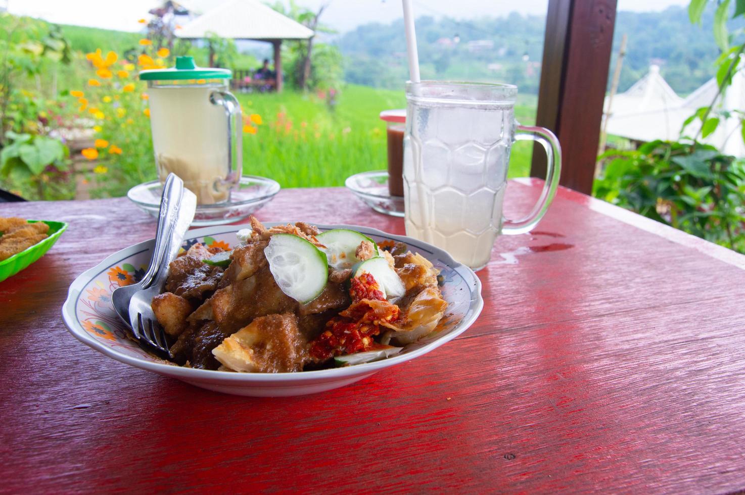 batagor with peanut sauce on a wooden table. photoshoot on a table in the open. photo