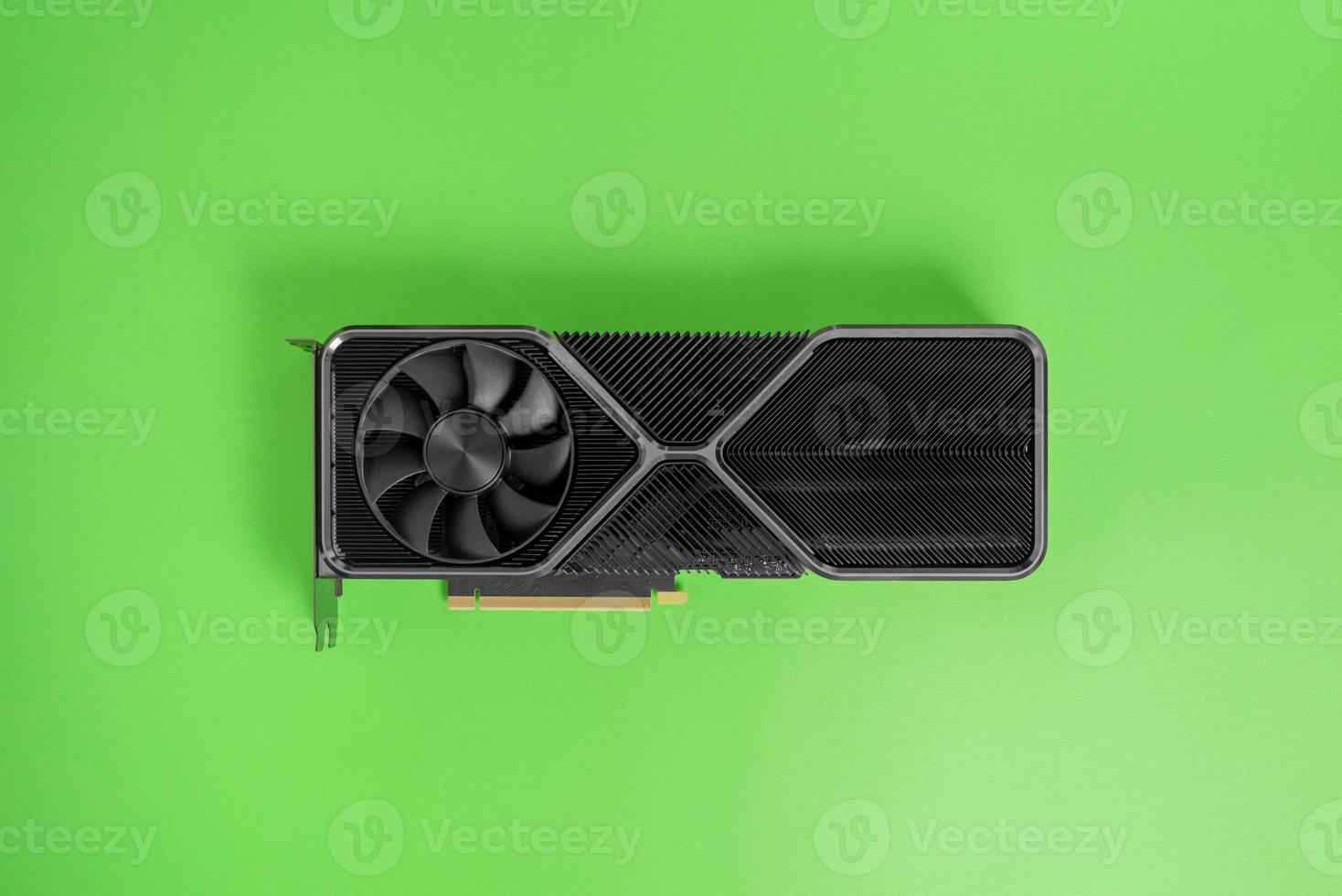 Modern graphic card on green surface. Massive radiator with two coolers