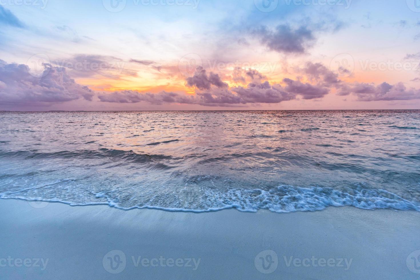 Sunset sea sand sky. Beautiful beach nature, soft sunlight and splashy waves cloudy colorful sky with sunlight. Tranquil beach landscape, calmness and inspiration view. Ocean water ecology concept photo