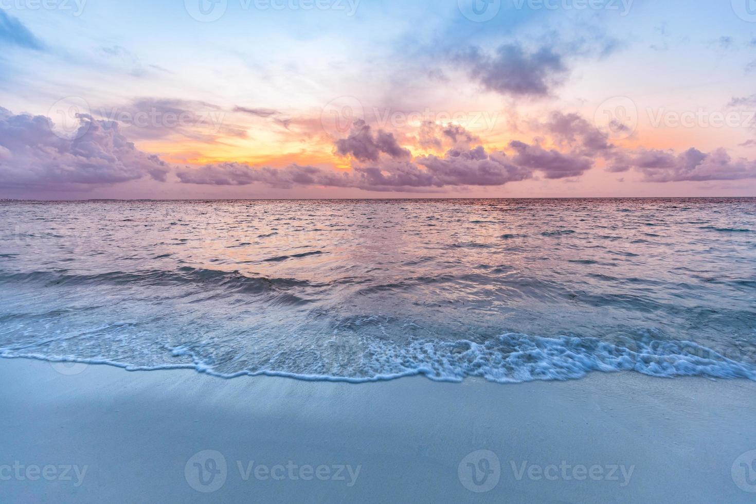 Sunset sea sand sky. Beautiful beach nature, soft sunlight and splashy waves cloudy colorful sky with sunlight. Tranquil beach landscape, calmness and inspiration view. Ocean water ecology concept photo