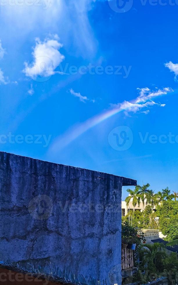 hermoso arco iris doble raro en el fondo azul cielo nublado méxico. foto