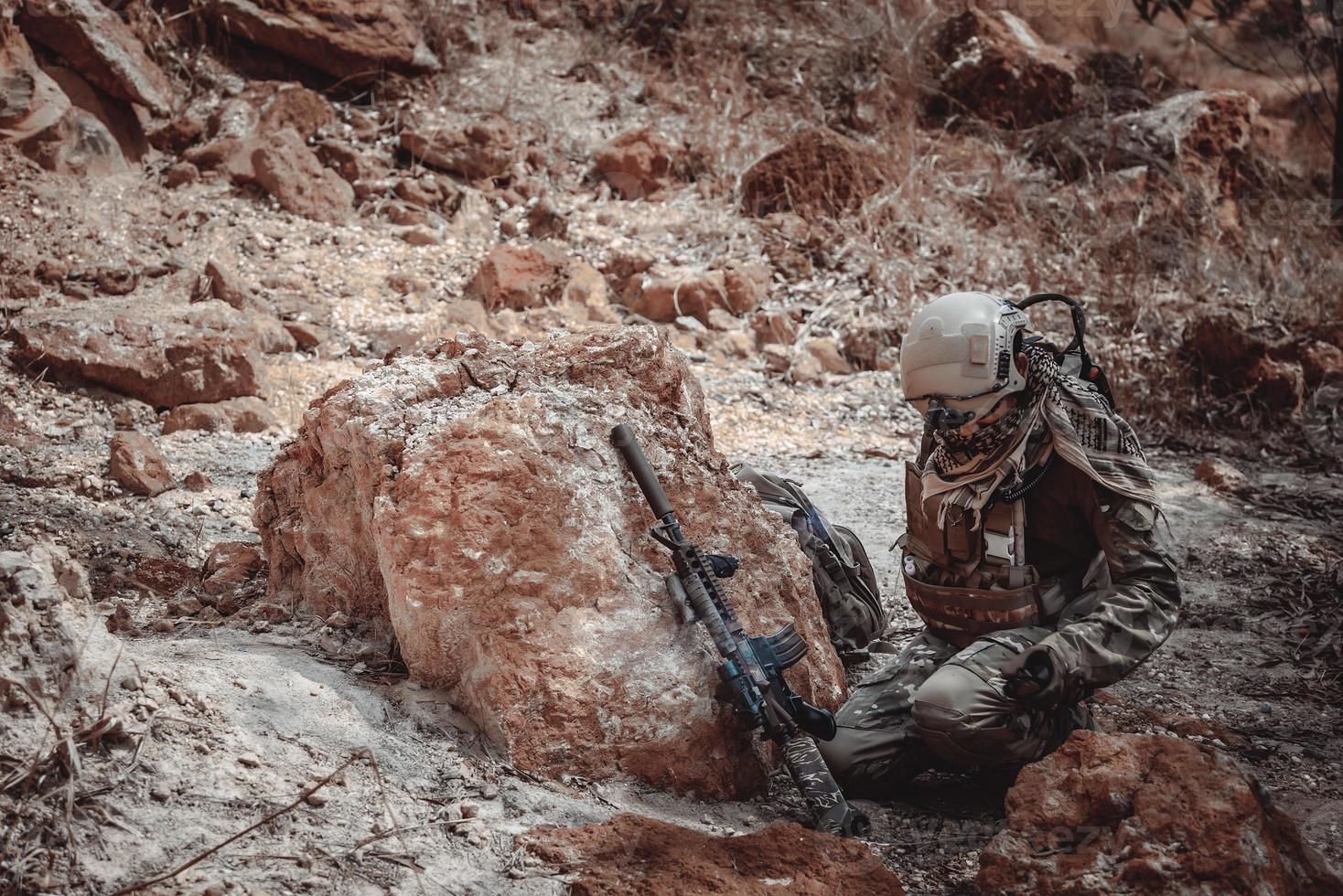 Soldiers of special forces on wars at the desert,Thailand people,Army soldier use laptop for see map with satellite,Using Radio For Communication During Military Operation photo