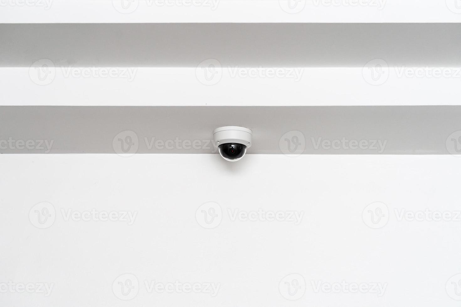CCTV camera is installed inside the building on the ceiling and wall for monitoring and running safety system control in that area. photo