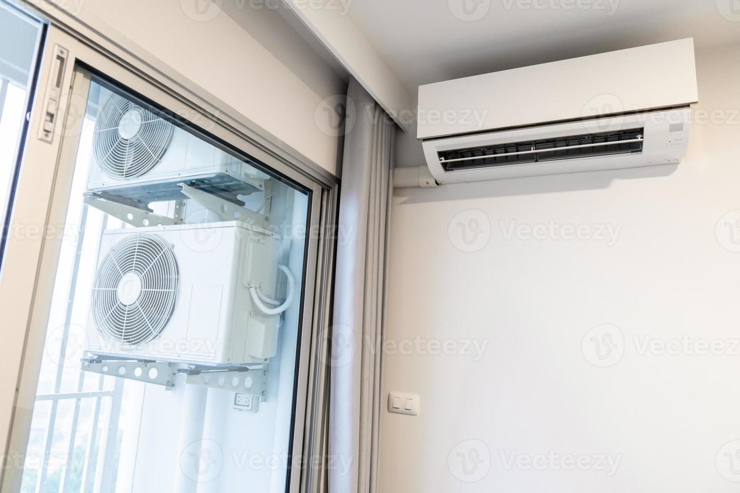 two air conditioning compressors are hung on wall. photo
