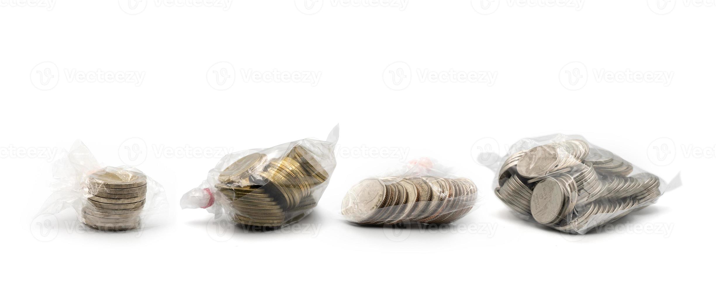 4 types of Thai Coin 1, 2, 5, 10 baht in plastic pack arranged together, shoot with studio light on white background. photo