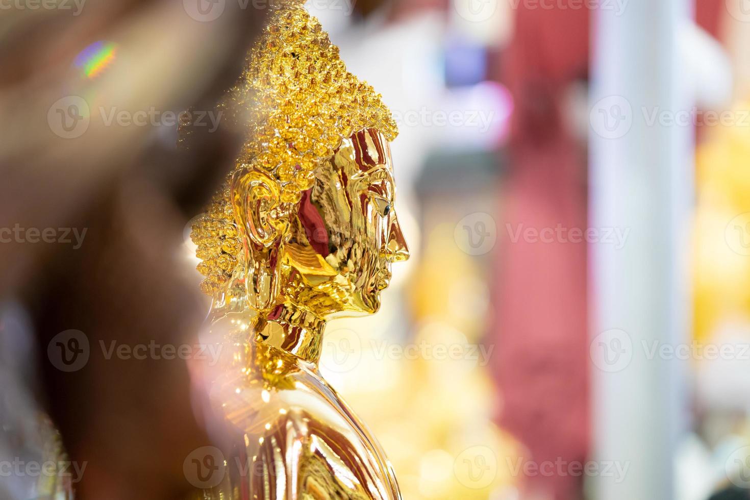 Close up to the Asia antique brightness and glitter Buddha statue inside Thailand Temple. photo