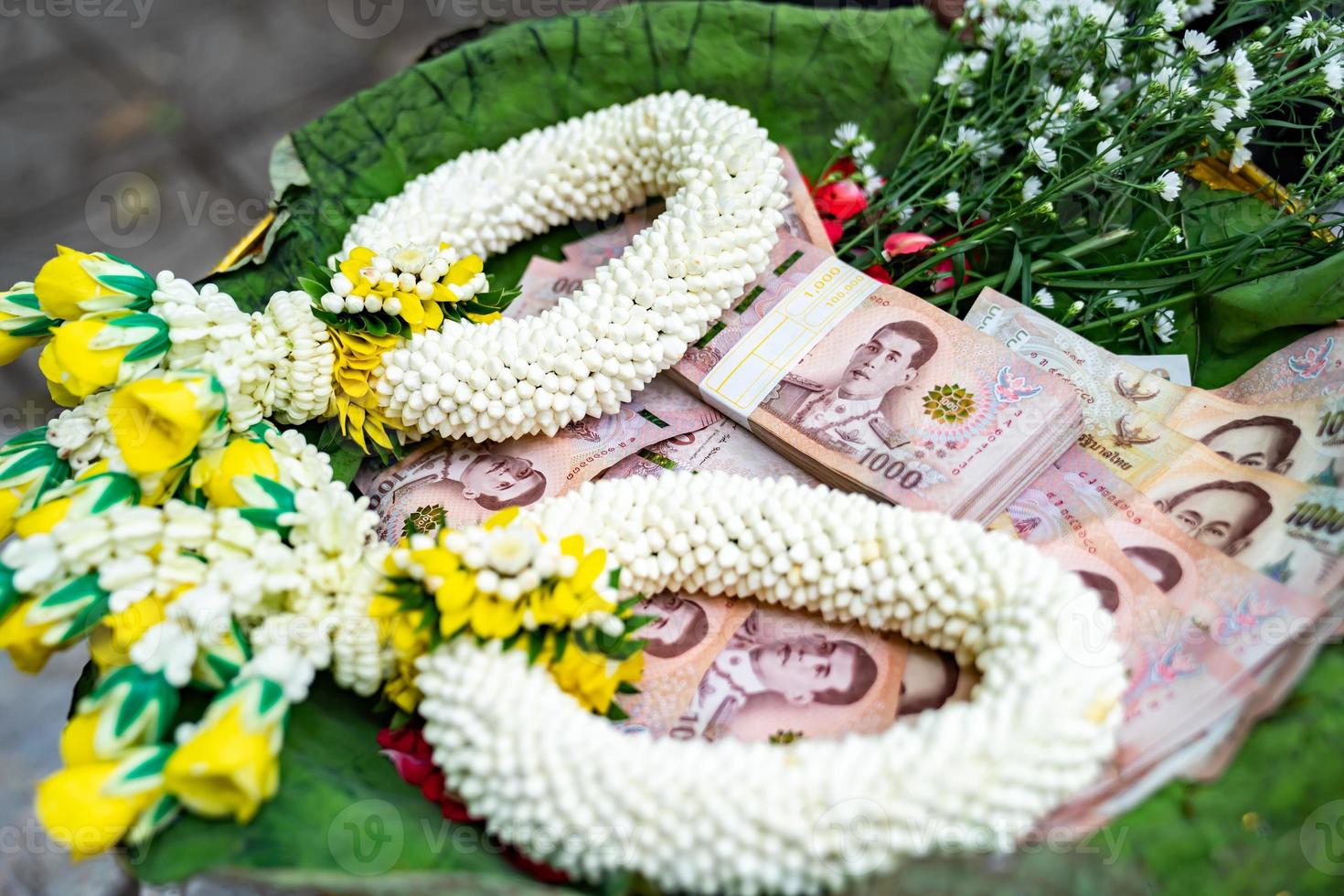 Thai Banknote 1000 Baht in Phan tray with pedestal with graland to make merit and to donate money to charity in Thai Traditional way. photo