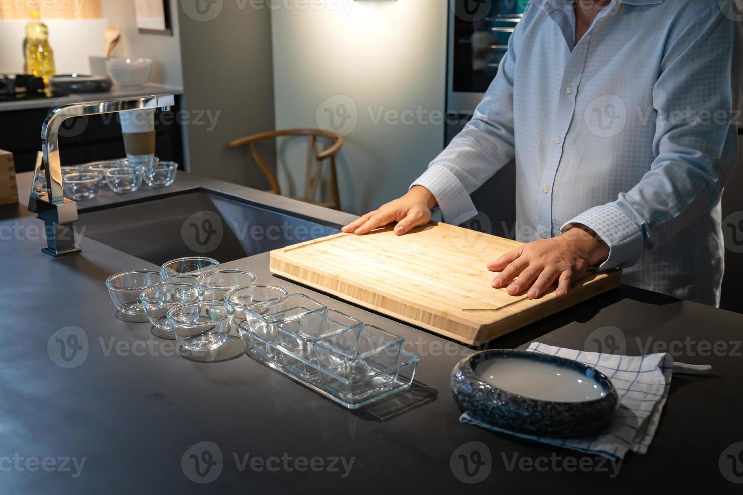 Environment of Asian Chef who lays his hand on wood cutting board shows sign of readiness for cooking menu today. photo