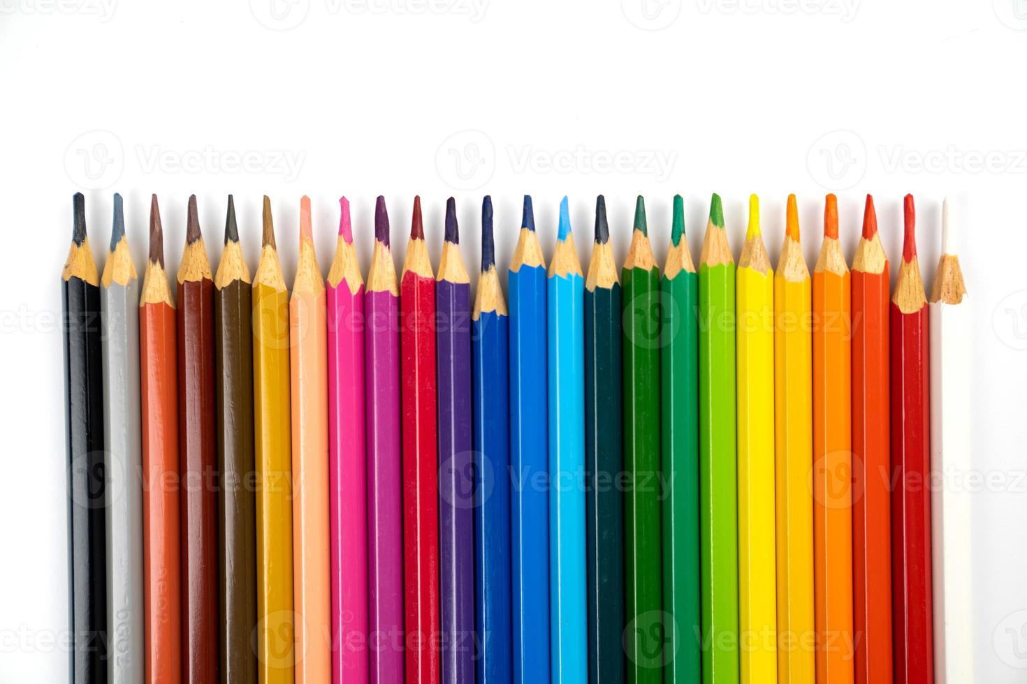 blunt colour pencils are arranged in the line on the white background and ready to paint. photo