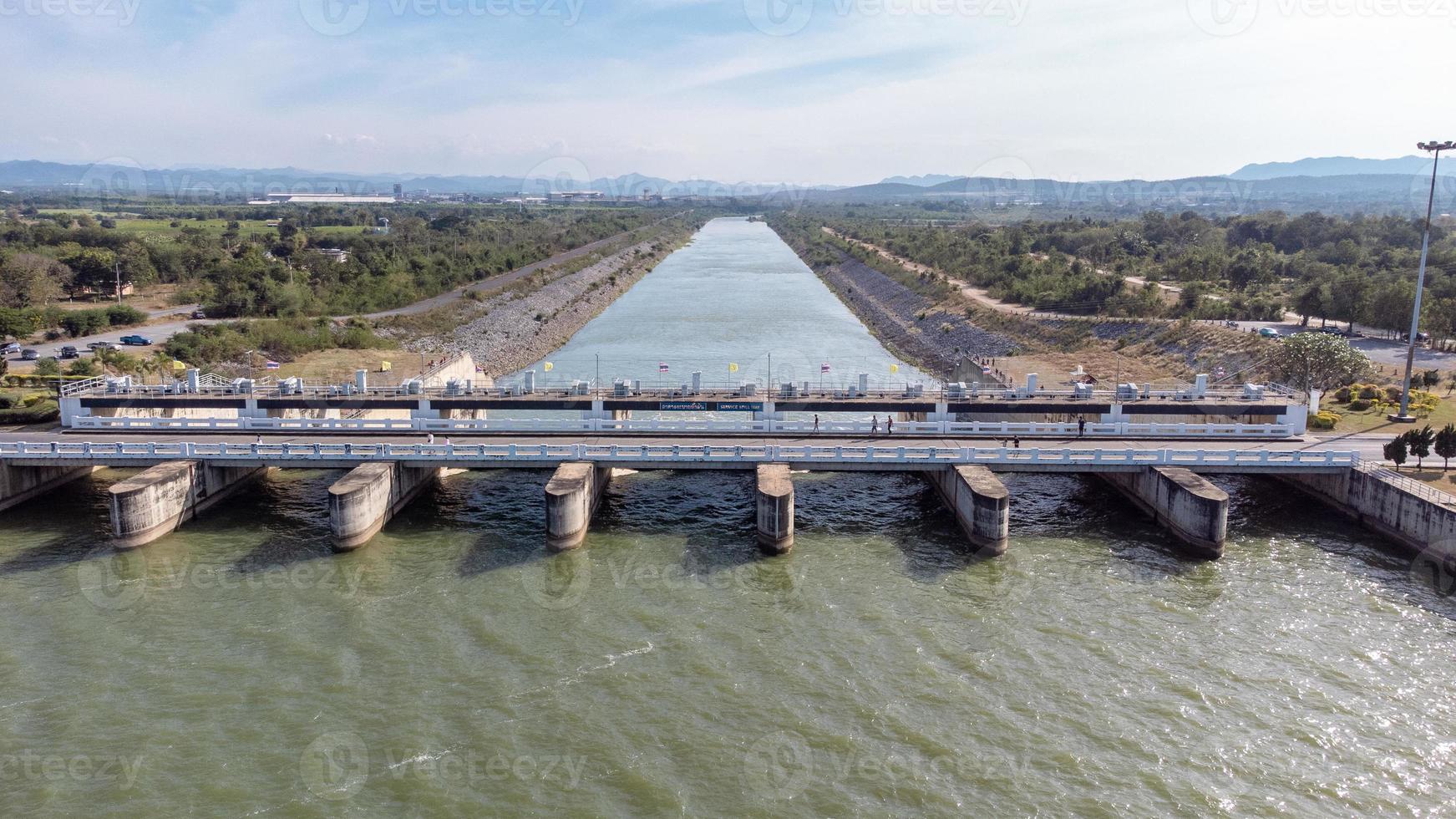 An aerial view over the Pasak Jolasid dam, Lopburi Province, Thailand. Tracking the movement of the floodgates that are releasing water into rural canals in enormous amounts of water. photo