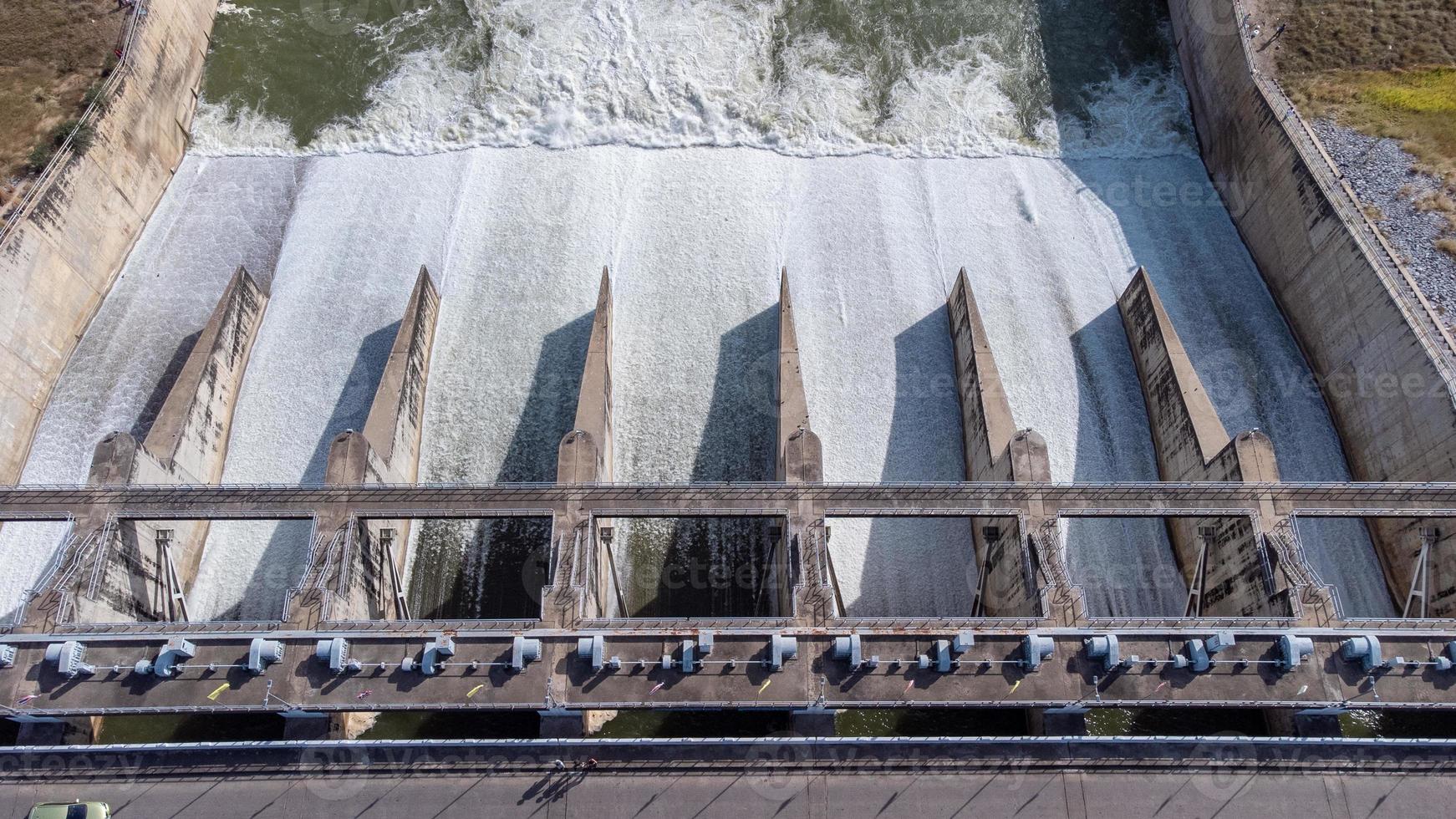 una vista aérea de la presa pasak jolasid, provincia de lopburi, tailandia. rastreando el movimiento de las compuertas que están liberando agua en los canales rurales en enormes cantidades de agua. foto