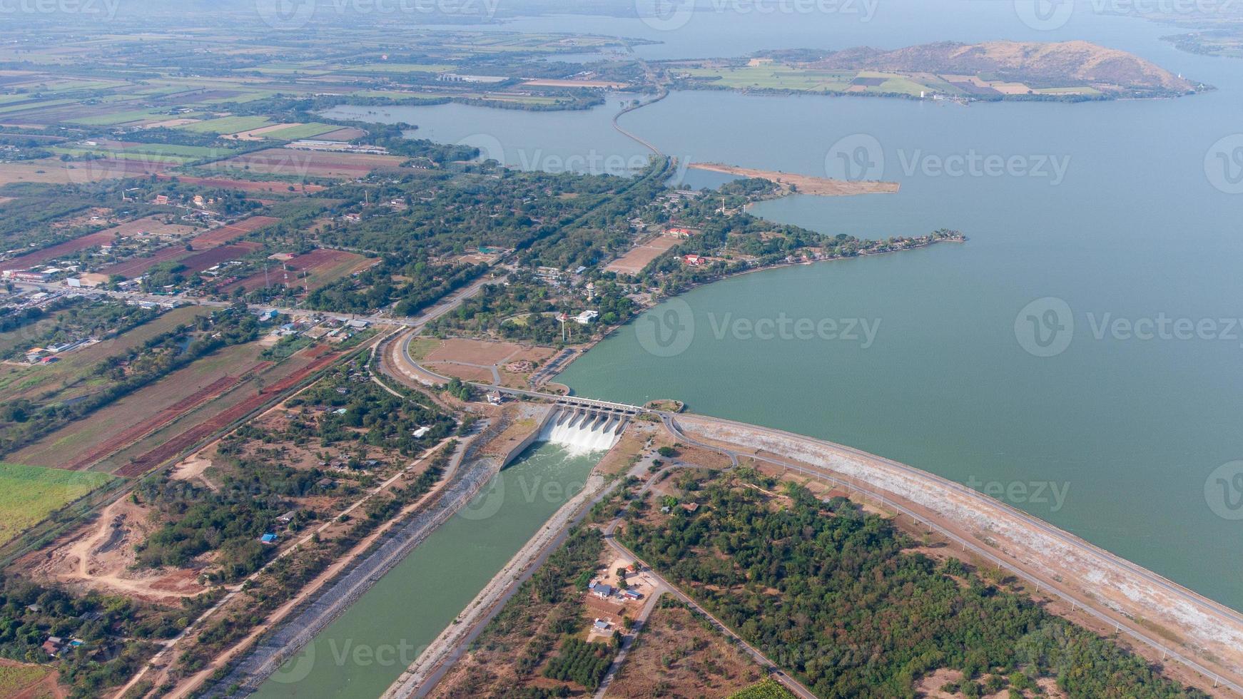 An aerial view over the Pasak Jolasid dam, Lopburi Province, Thailand. Tracking the movement of the floodgates that are releasing water into rural canals in enormous amounts of water. photo