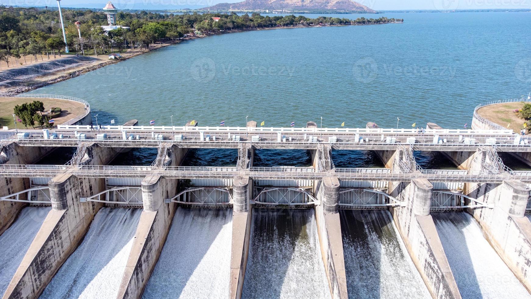 An aerial view over the Pasak Jolasid dam, Lopburi Province, Thailand. Tracking the movement of the floodgates that are releasing water into rural canals in enormous amounts of water. photo