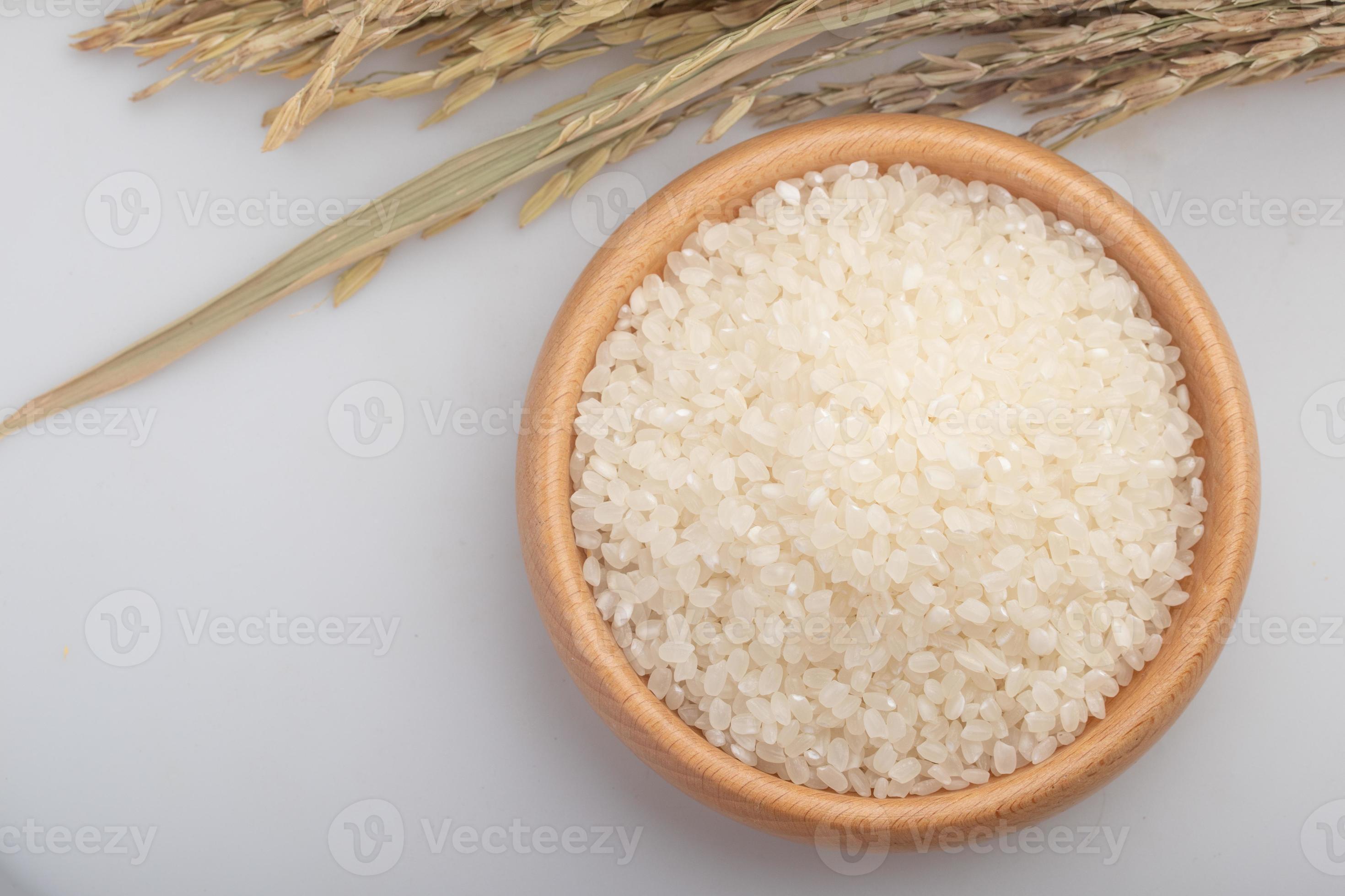 Raw Japanese rice grains, Japonica rice grains. In a wooden cup