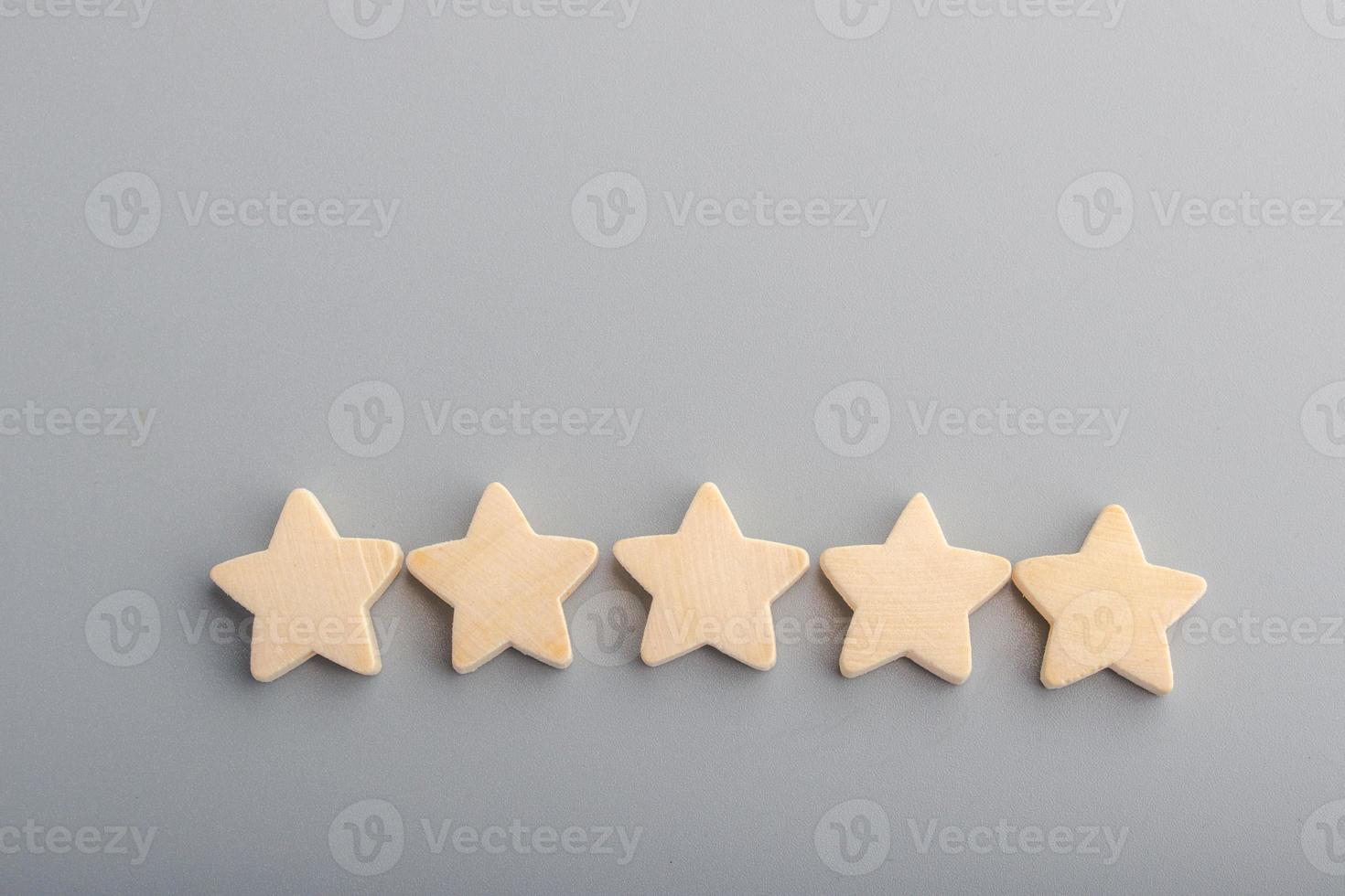 Five wooden stars on gray background.Copy space. photo