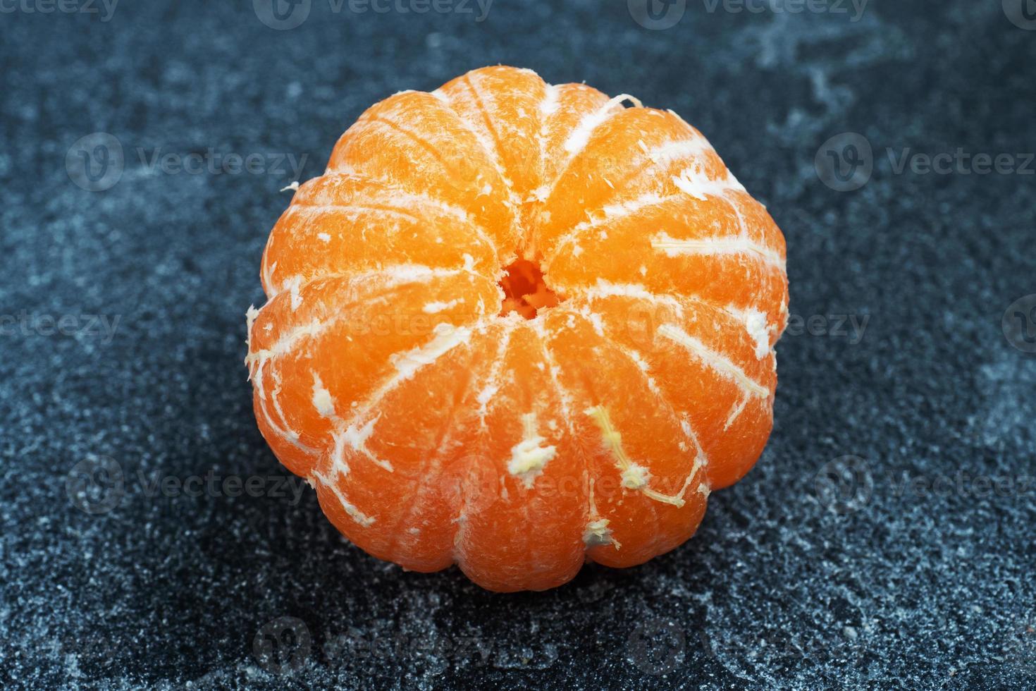 Peeled without skin Oranges tangerines or mandarins clementines, citrus fruits on a dark background. photo