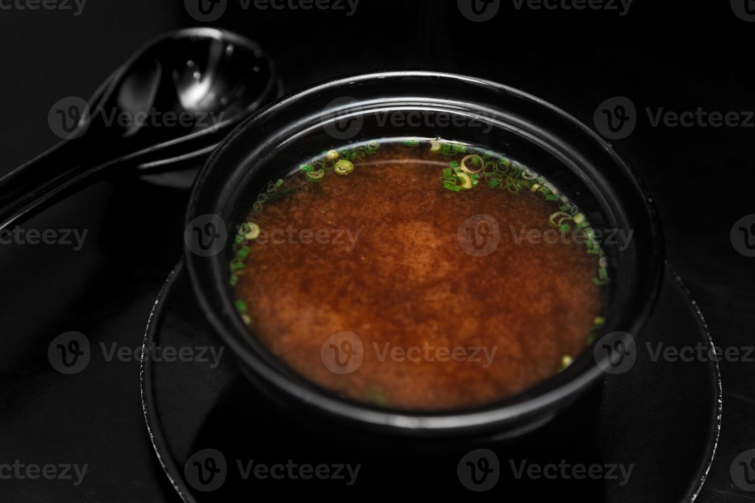 spicy chinese soup on a black background photo