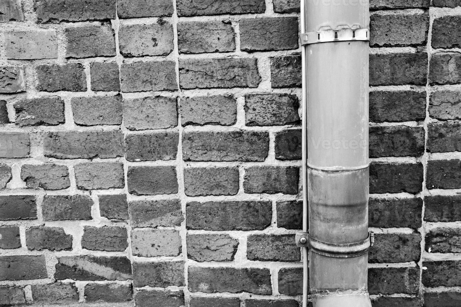 brick wall with rain pipe photo