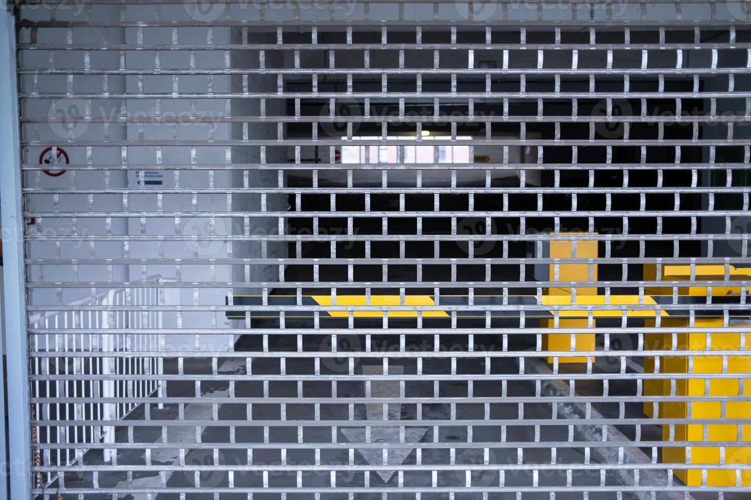 barred metal gate to underground garage photo