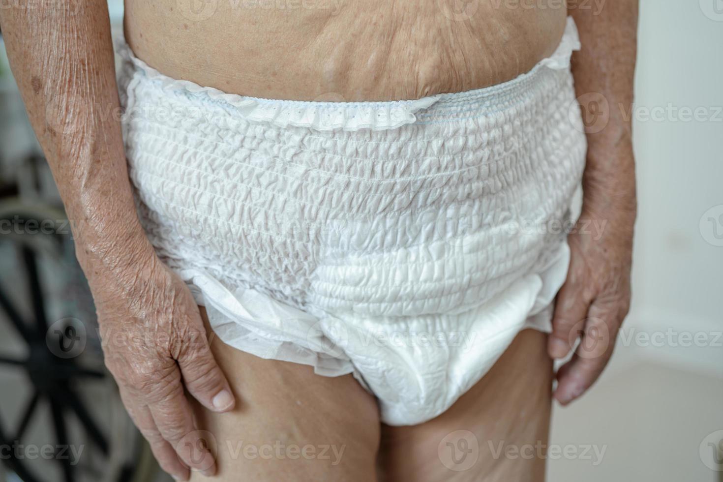 Asian senior or elderly old lady woman patient wearing incontinence diaper in nursing hospital ward, healthy strong medical concept. photo