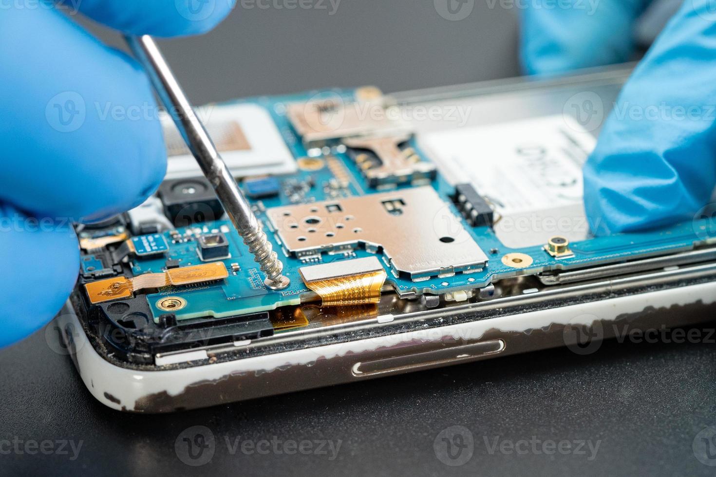technician repairing inside of hard disk by soldering iron. Integrated Circuit. the concept of data, hardware, technician and technology. photo