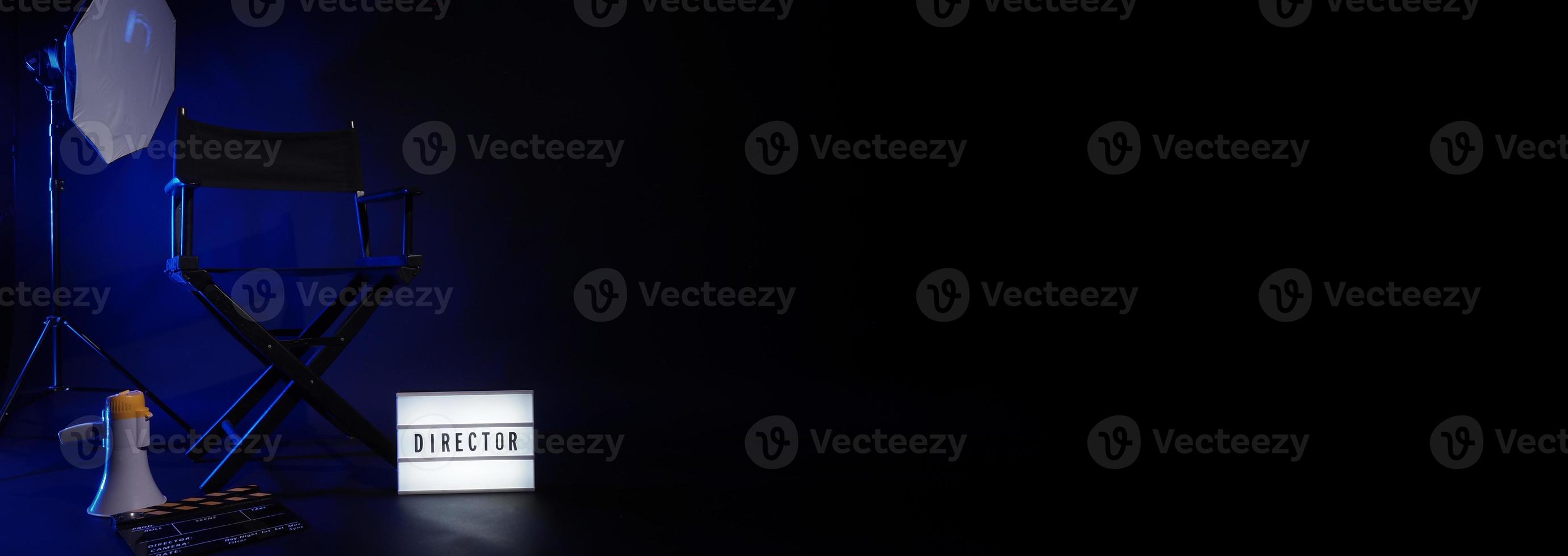 Director chair with cinema lightbox sign Director text on it and clapperboard megaphone photo