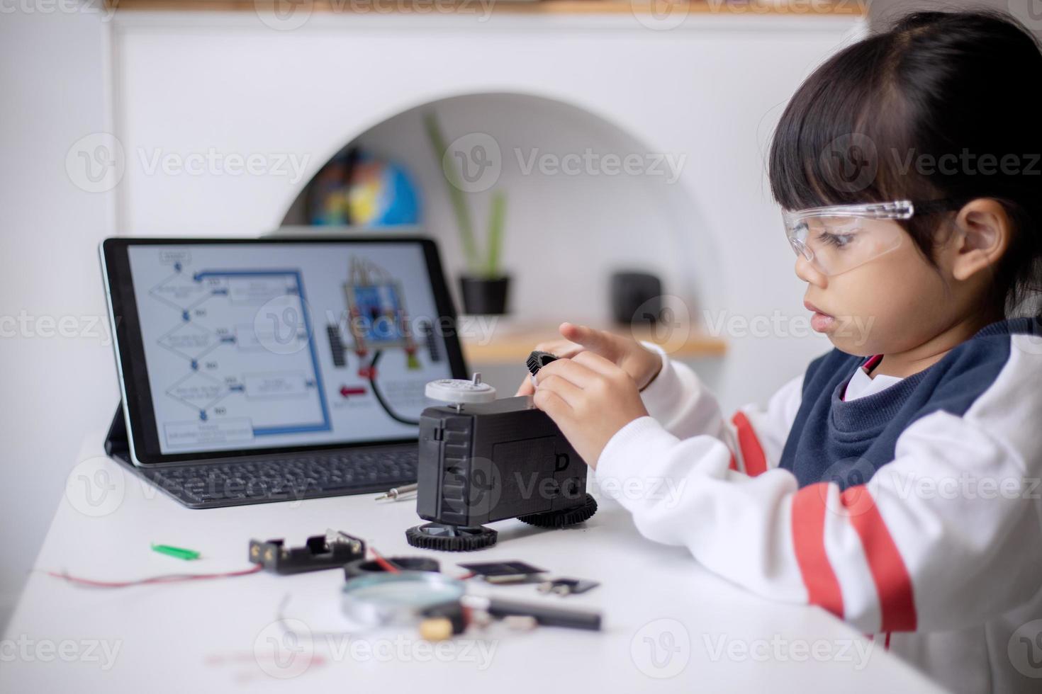 Asia students learn at home in coding robot cars and electronic board cables in STEM, STEAM, mathematics engineering science technology computer code in robotics for kids concept photo