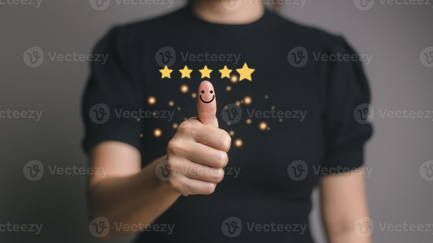 Customer satisfaction concept. Hand with thumb up Positive emotion smiley face icon and five star with copy space. photo