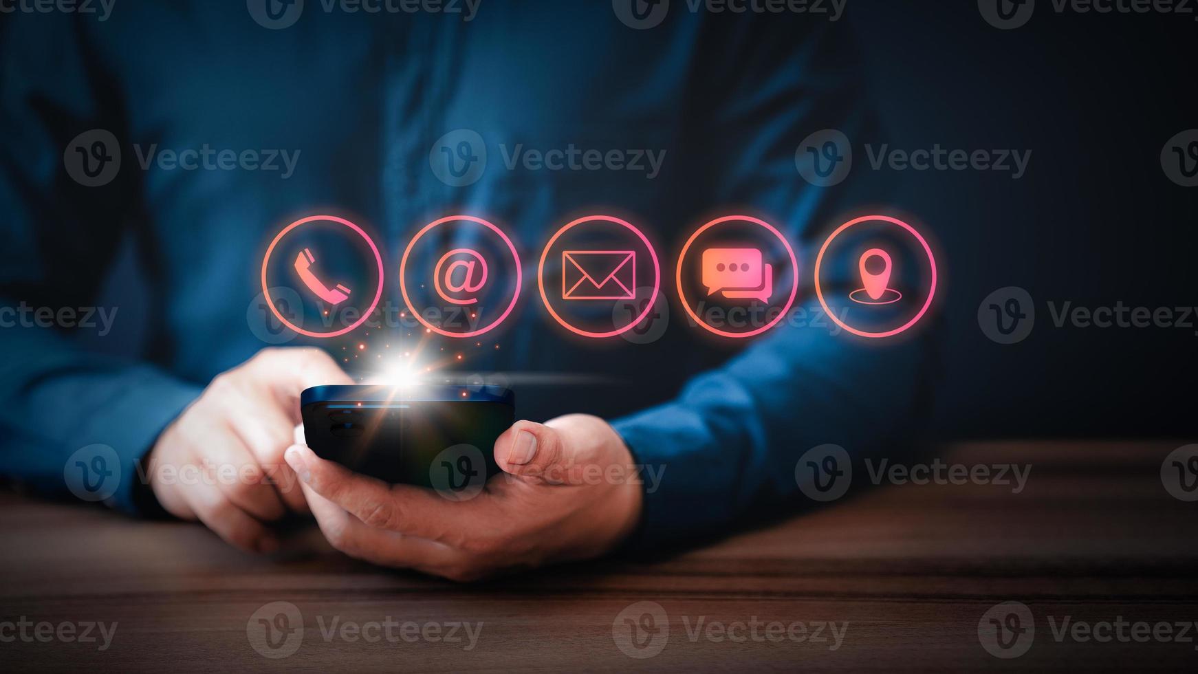 Businessman using mobile phone or smartphone with the call phone, email, address, chat message and map icons. Customer support hotline contact us people connection concept. photo