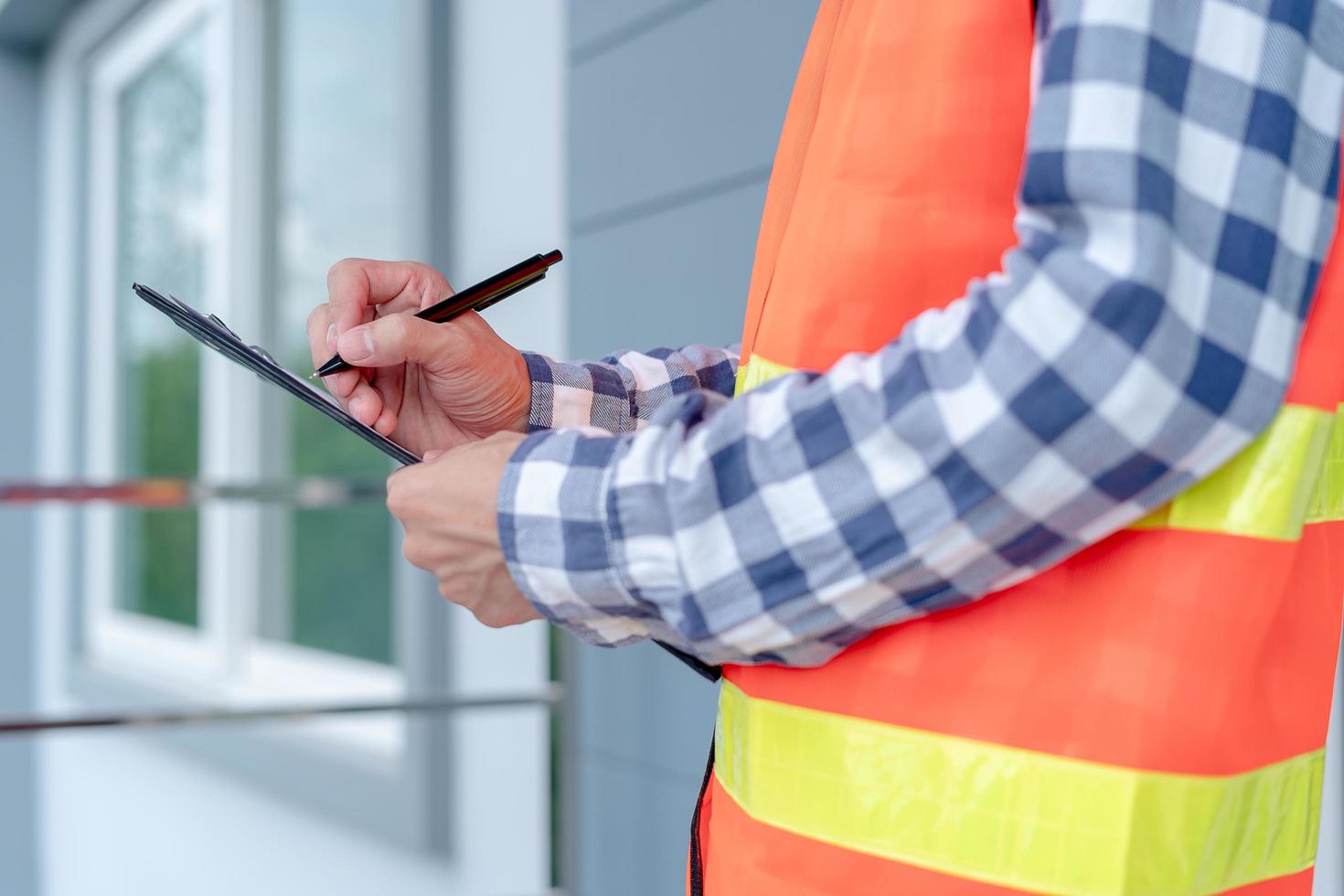 Inspector or engineer is checking and inspecting the building or house by using checklist. Engineers and architects work on building the house before handing it over to the landlord. photo